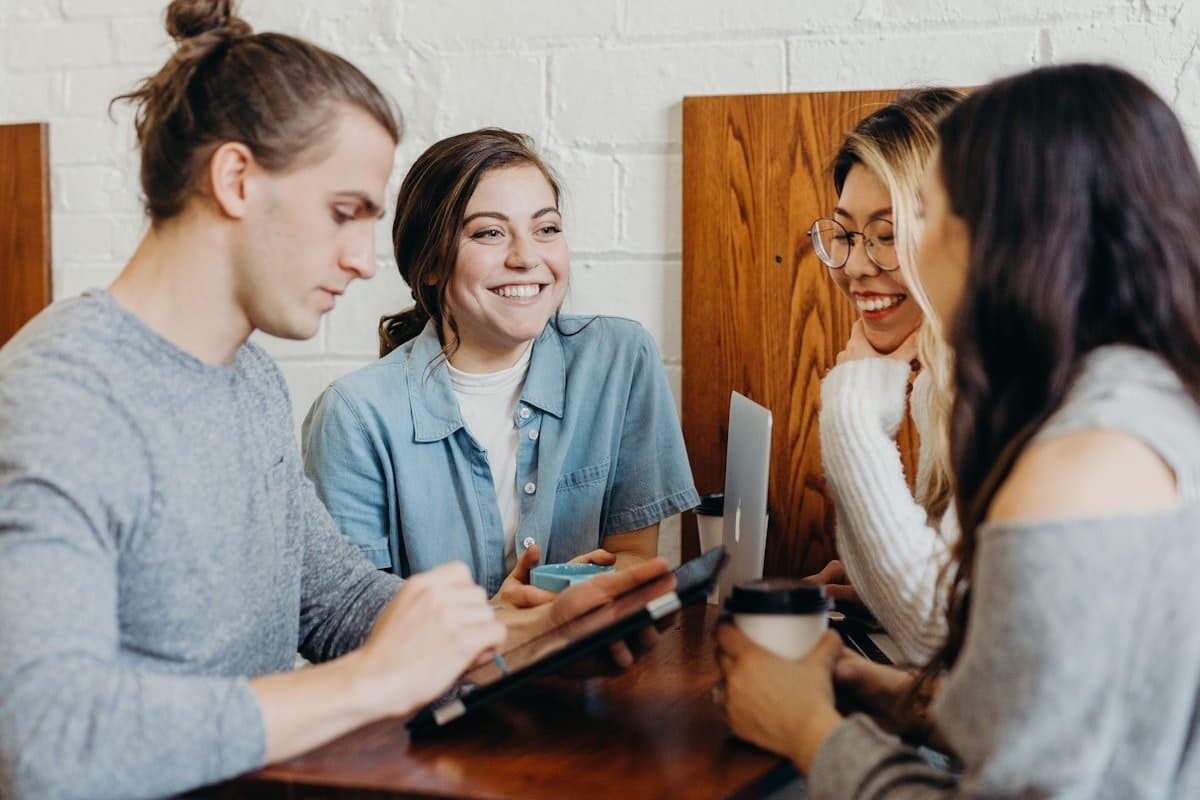 Colleagues collaborating around a table in an encouraging team meeting